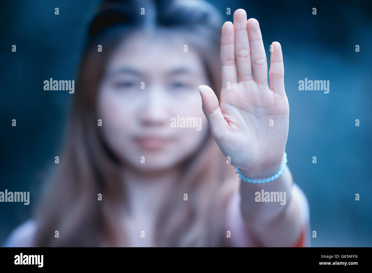 Asian women showing stop hand gesture,  focus hand Stock Photo
