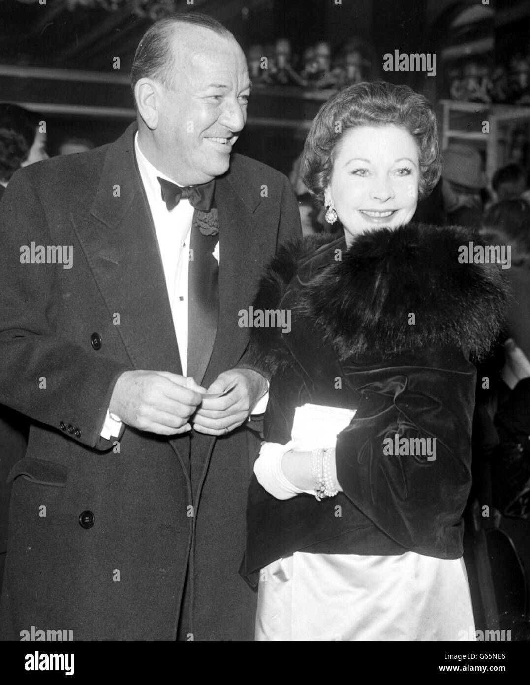 Noel Coward, who is celebrating his 59th birthday arrives with actress Vivien Leigh for the first night of 'Who's your father?' at the Cambridge Theatre, London. Stock Photo