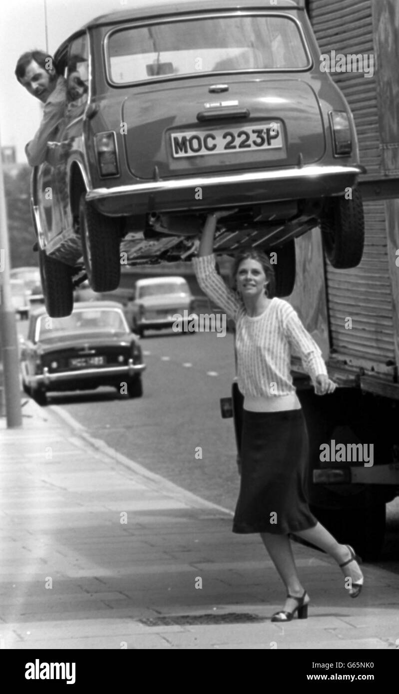 Living up to her super strength image by feigning to lift a mini suspended above the pavement outside Thames Television's Euston Road studios is 26-year-old American actress Lindsay Wagner who is in London to launch her TV series The Bionic Woman. The new series was created after she appeared as a partner for Colonel Steve Austin (actor Lee Majors) in a two-part episode of The Six Million Dollar Man, and the ratings soared. Stock Photo