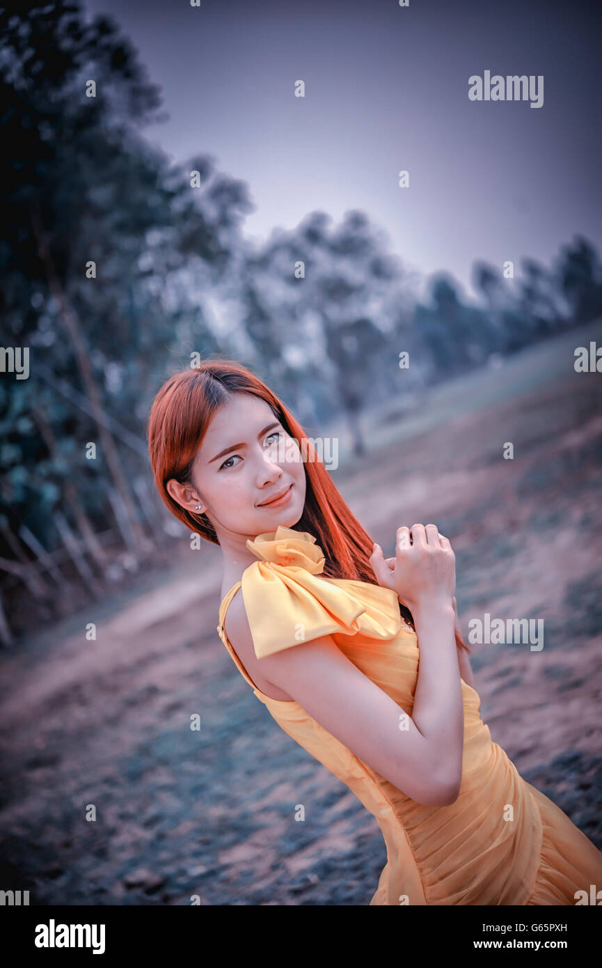 Portrait of Asia Beautiful woman in yellow dress on nature Stock Photo ...