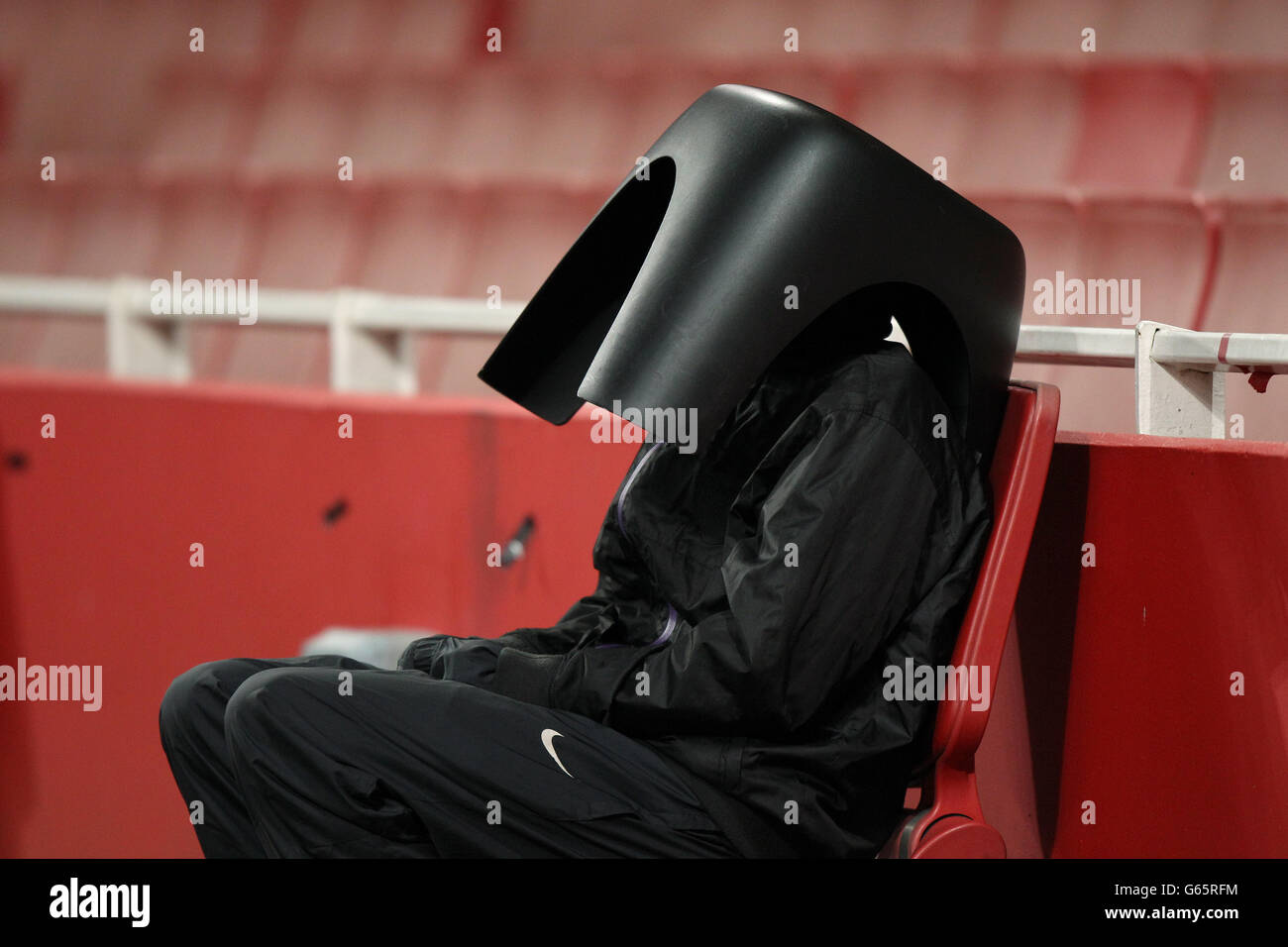A bellboy shelters from the elements underneath a stool, during the ...