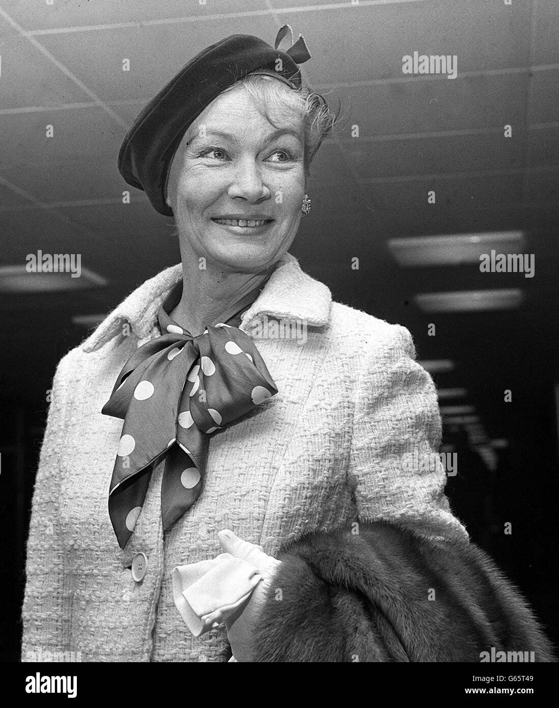 Veronica Lake, the 1940s film star with the blonde peek-a-boo hairstyle, now recovered from the fever which prevented her from coming to appear in a recent Eamonn Andrews TV show, on arrival at Heathrow airport. Stock Photo