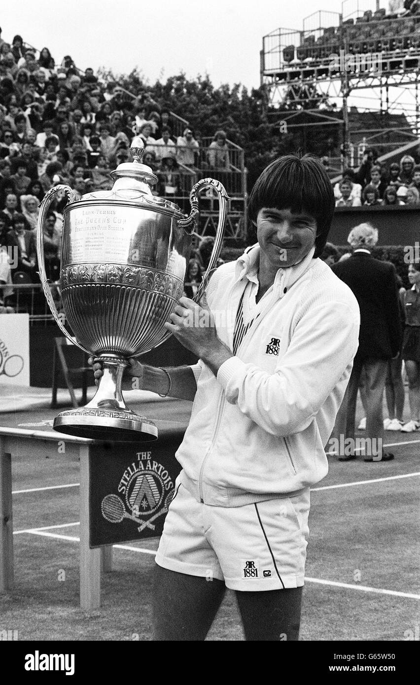 With a trophy almost as tall as himself, America's Jimmy Connors grins  broadly at Queen's Club after defeating his compatriot John McEnroe in the  singles final of the Stella Artois grass court