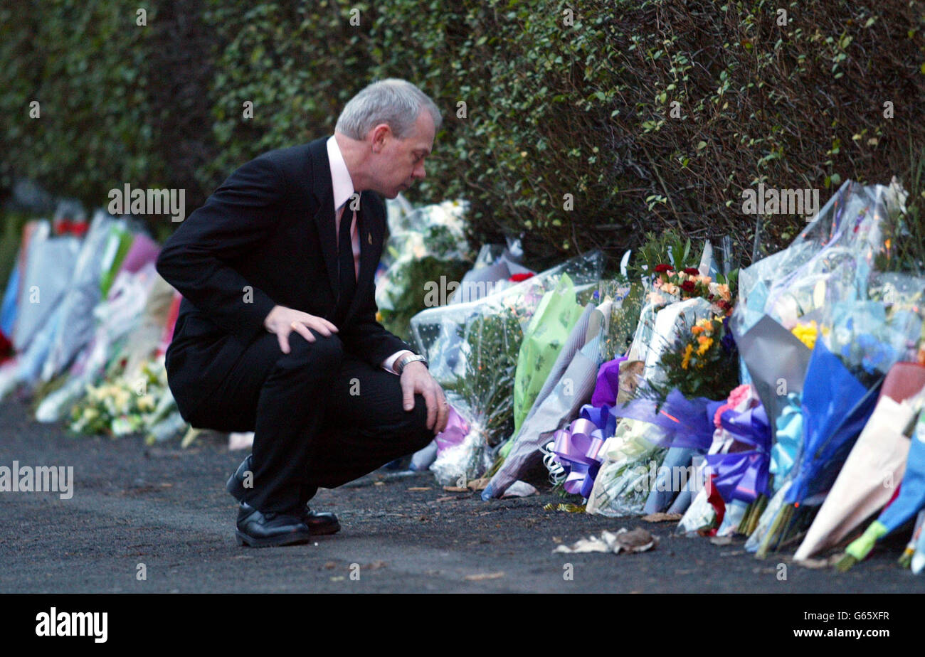 Tony Rae, Chairman of the Police Roll Of Honour Trust, lays flowers for DC Stephen Oake along Crumpsall Lane in Manchester where Mr Oake was stabbed to death during an anti-terrorism raid on Tuesday. * Mr Oake, a father-of-three from Poynton in Cheshire, who served with the forces's Special Branch, died at North Manchester General Hospital after receiving emergency treatment at the scene. Stock Photo