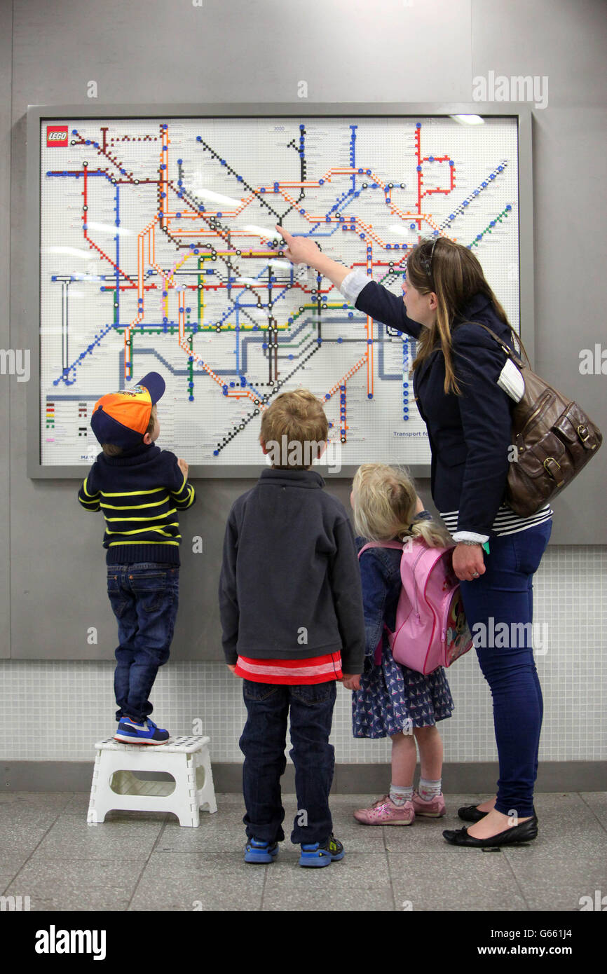 EDITORIAL USE ONLY A family look at a 2020 Tube map of the future, made entirely from LEGO Bricks, at Londons Kings Cross Station to celebrate 150 years of the London Underground. Stock Photo