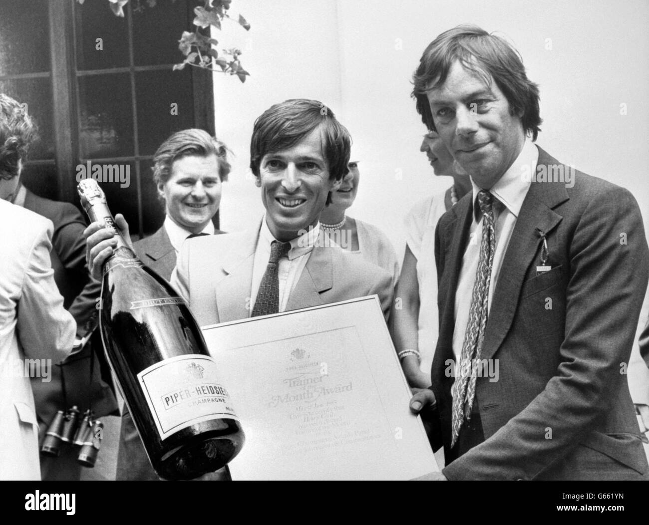 Horse trainer Henry Cecil (right), receiving the Piper Champagne Trainer of the Month awards for May and June, at the Newmarket races following the Piper Champagne Maiden Stakes, as Giles de Courcel (left), Export director of Piper-Heidsieck Champagne, Reims, hands over one of the two jeroboam prizes. Stock Photo