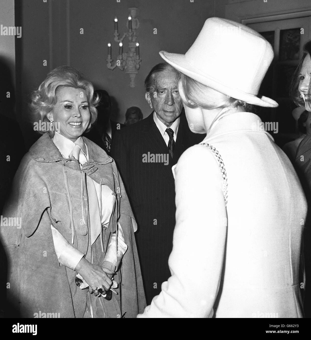 The Duches of Kent (back to canera), seen during her visit to Oxfam's Mayfair Fair at Grosvenor House, where she met the Fair's President, Mr Paul Getty the American oil millionaire, and his guest, Hollywood actress, Zsa Zsa Gabor. The Fair is to raise money for Oxfam's aid to developing countries. Miss Gabor is due to compere the entertainment at the Fair which ends in the early hours. Stock Photo