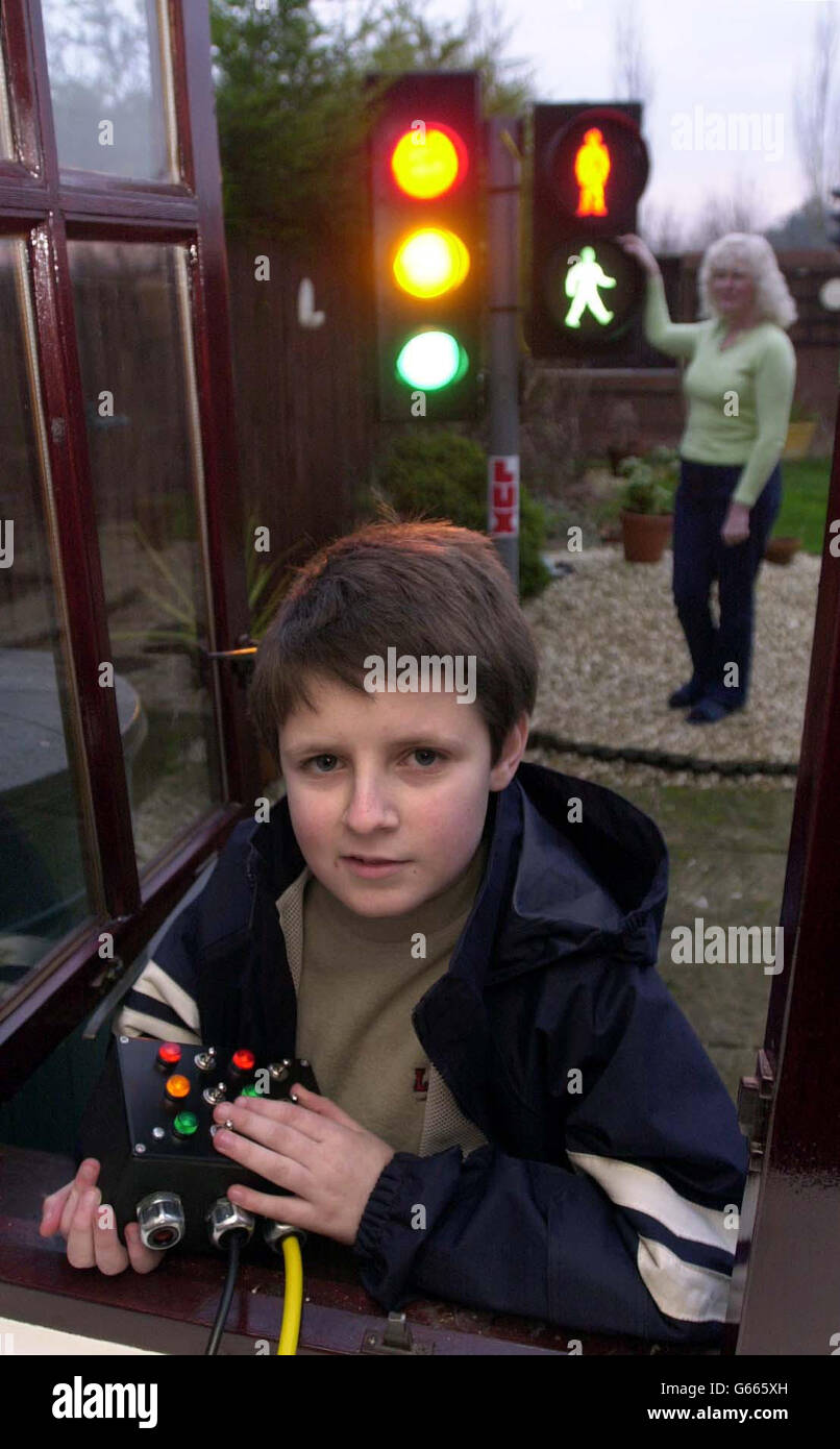 Autistic Benjamin Brittain, 11, stands in front of the traffic lights at his home in Melksham, Wiltshire. The 11-year-old, who was diagnosed with Asperger's Syndrome at the age of three, has always had a fascination with traffic lights, pedestrian crossings and, in particular, *..the little green man. A local firm said they could install a full set, complete with pedestrian red and green men, for free in the Brittains' garden after Benjamin's mother asked if they could make a model set. Stock Photo