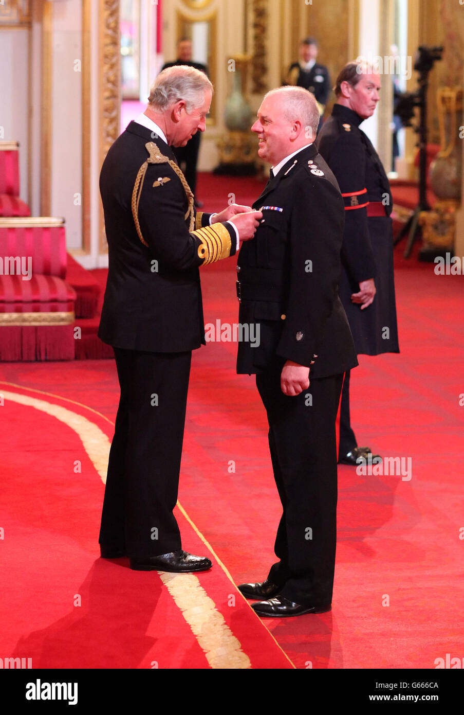 Chief Constable of Staffordshire Police Michael Cunningham is decorated with the Queen's Police Medal by the Prince of Wales at an Investiture ceremony at Buckingham Palace, central London. Stock Photo