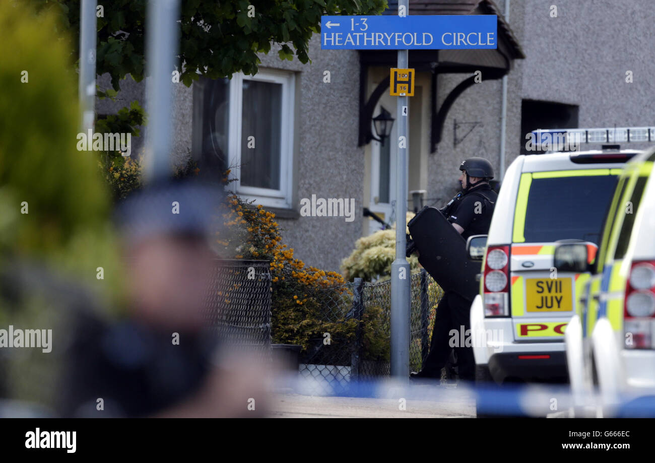 Police outside a flat in the Heathryfold area of Aberdeen, responding to an incident involving a man who remains inside. Stock Photo