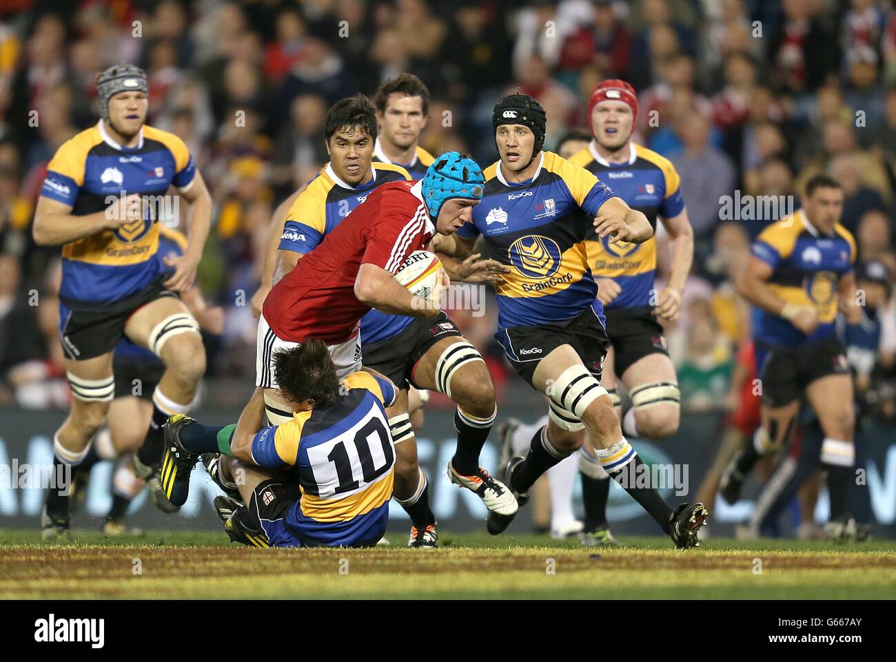 British & Irish Lions' Justin Tipuric (centre) is tackled by NSW-Queensland Country's Angus Roberts (floor) Stock Photo