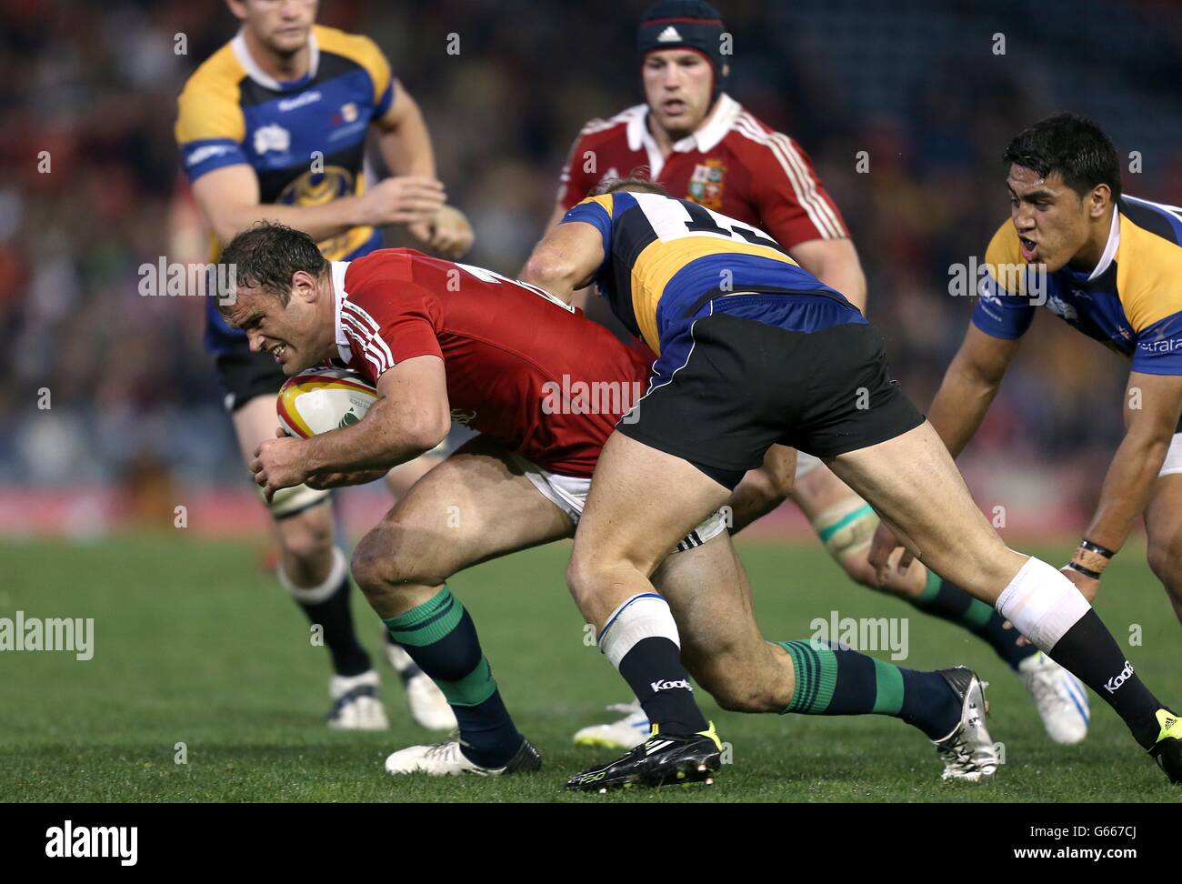 Rugby Union - 2013 British and Irish Lions Tour - NSW-Queensland Country v British & Irish Lions - Hunter Stadium. British & Irish Lions' Jamie Roberts (left) looks to break through the tackle of NSW-Queensland Country's Nathan Trist (centre) Stock Photo