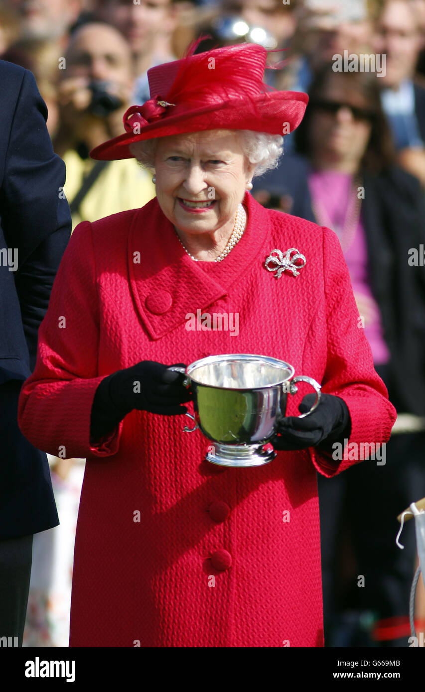 Queen Elizabeth II waits to present the Cartier Queen's Cup following