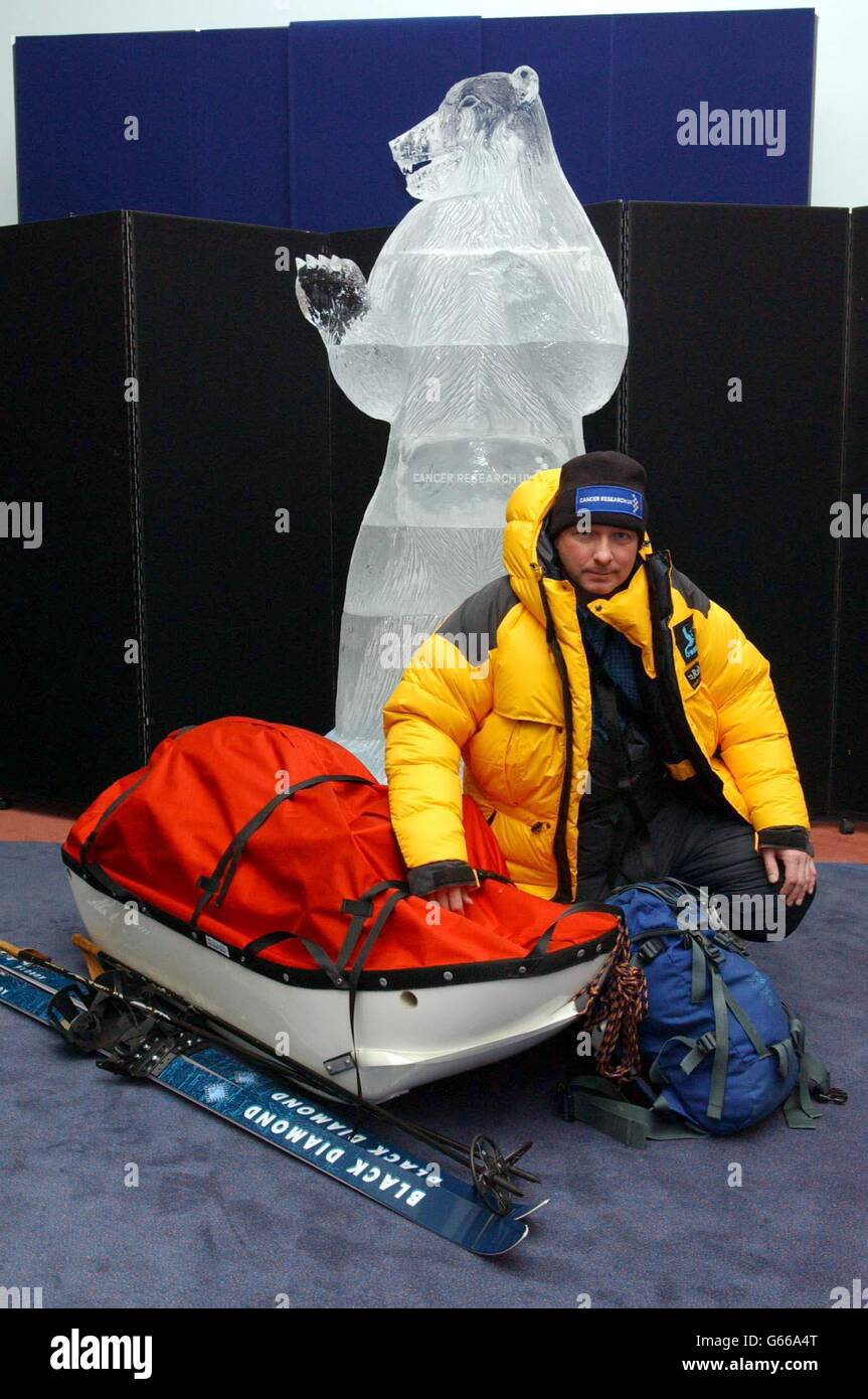 Jim McNeill, dressed in full polar suit and flanked by a 7'foot ice sculpture of a Polar Bear, during a photocall at the Natural History Museum, London, to launch his bid to become the first solo explorer to reach all four Arctic poles. *..McNeill, 42, a fire surveillance officer at Windsor Castle, hopes to smash five records on the ice adventure including walking to the Arctic, the Magnetic, the Geomagnetic and the Geographic poles, while raising awareness of Cancer Research UK. Stock Photo