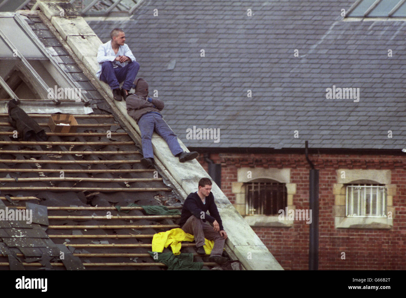 Three prisoners refuse to move from the roof of Strangeways prison. They lit a new series of fires after authorities kept them awake during the night with fire hoses and spotlights. Stock Photo