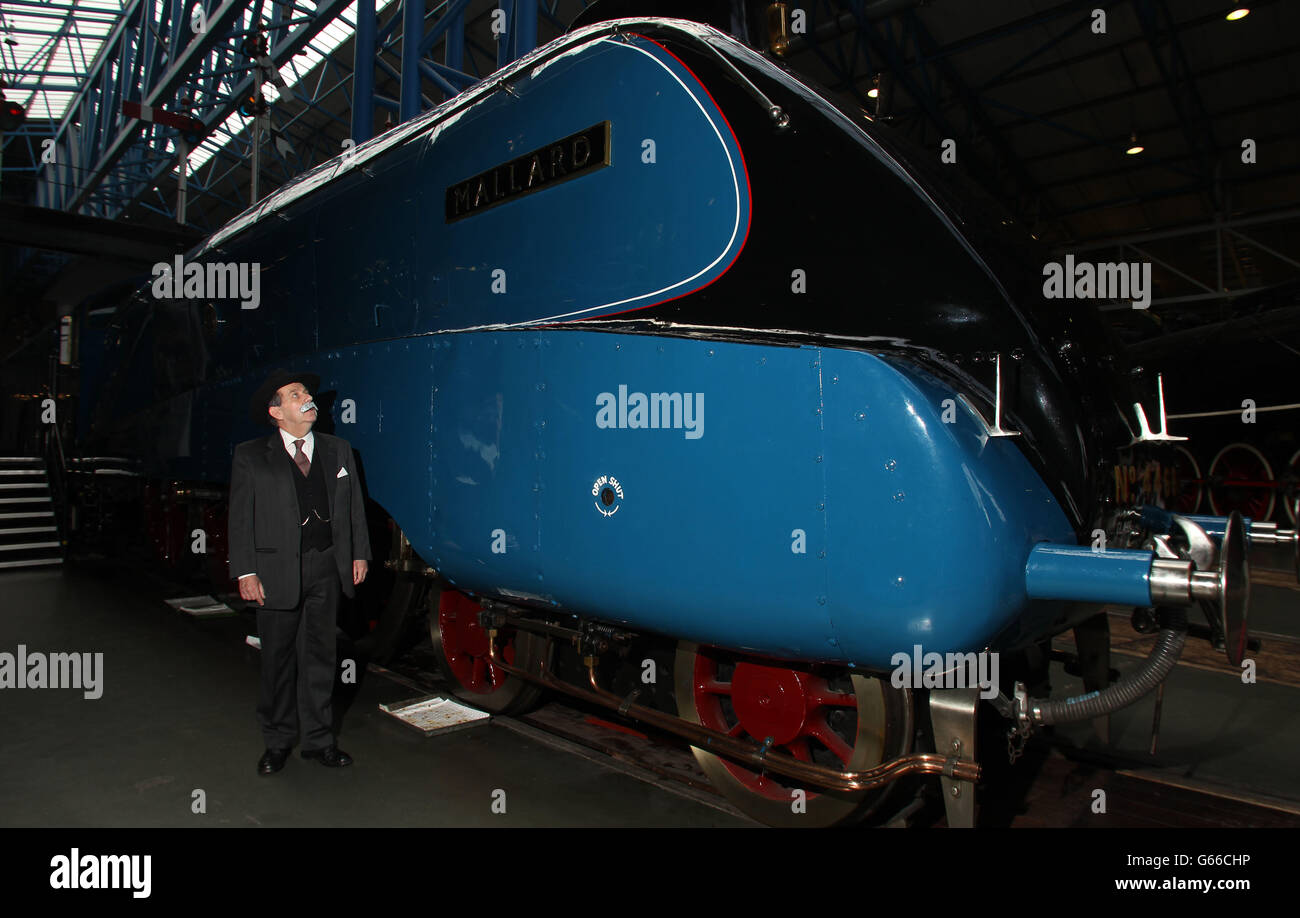 Chris Cade from Platform 4 Theatre dressed as Sir Nigel Gresley next to The Mallard, at The National Railway Museum, York as its marks the birthday of Sir Nigel Gresley in the run up to the 75th anniversary of The Mallard breaking the world steam record. Stock Photo