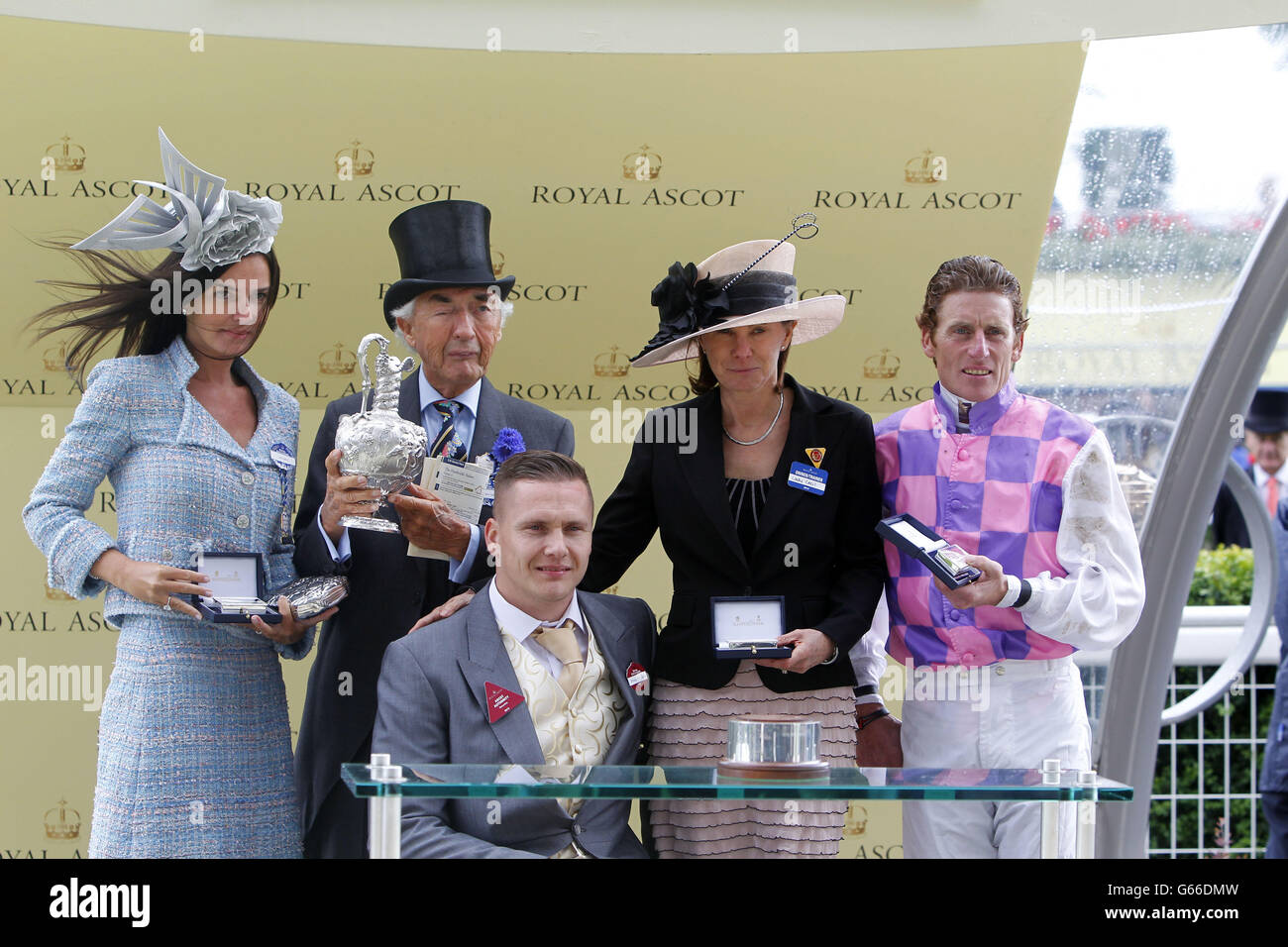 Thomas Chippendale ridden by Johnny Murtagh (R) with owners Sir and Lady Robert Ogden and Lady Cecil (second right) presented by David Weir (centre) after winning the Hardwicke Stakes during day five of the Royal Ascot meeting at Ascot Racecourse, Berkshire. Stock Photo