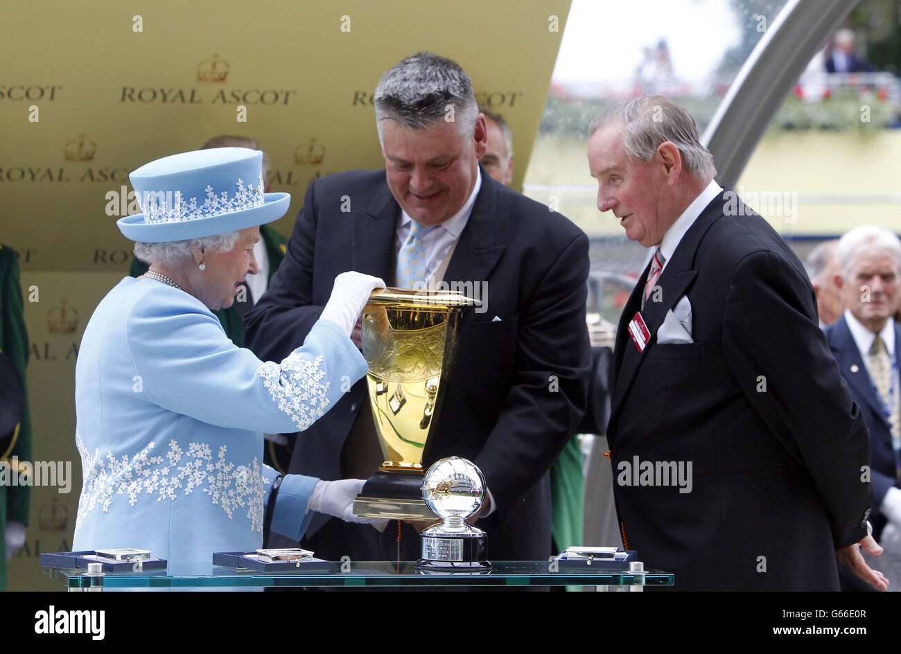Queen Elizabeth II presents the owner of Lethal Force which was ridden by Adam Kirby after it wins the Diamond Jubilee Stakes during day five of the Royal Ascot meeting at Ascot Racecourse, Berkshire. Stock Photo