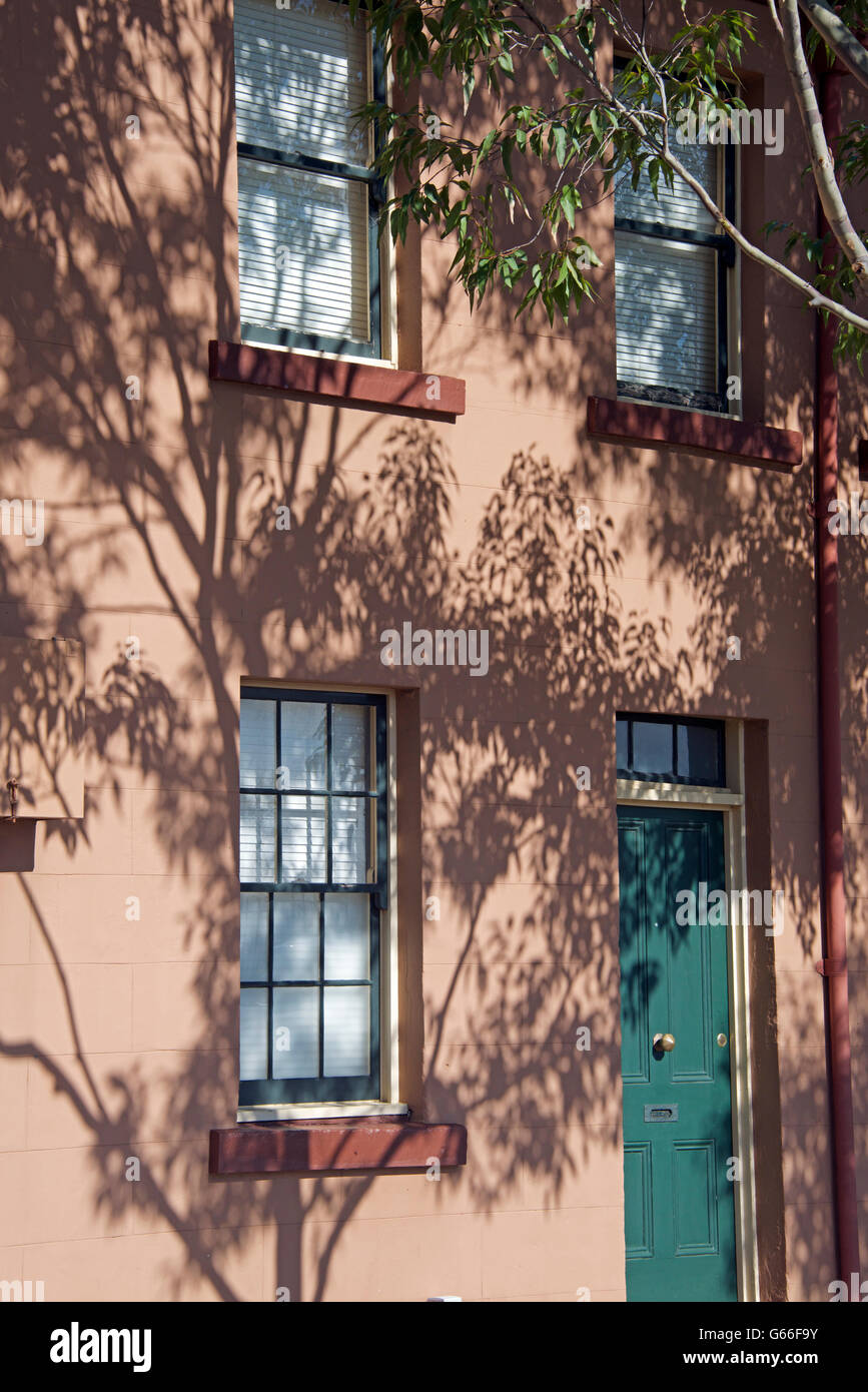 Old historic terrace house Merriman Street with tree shadows patternThe Rocks Sydney NSW Australia Stock Photo