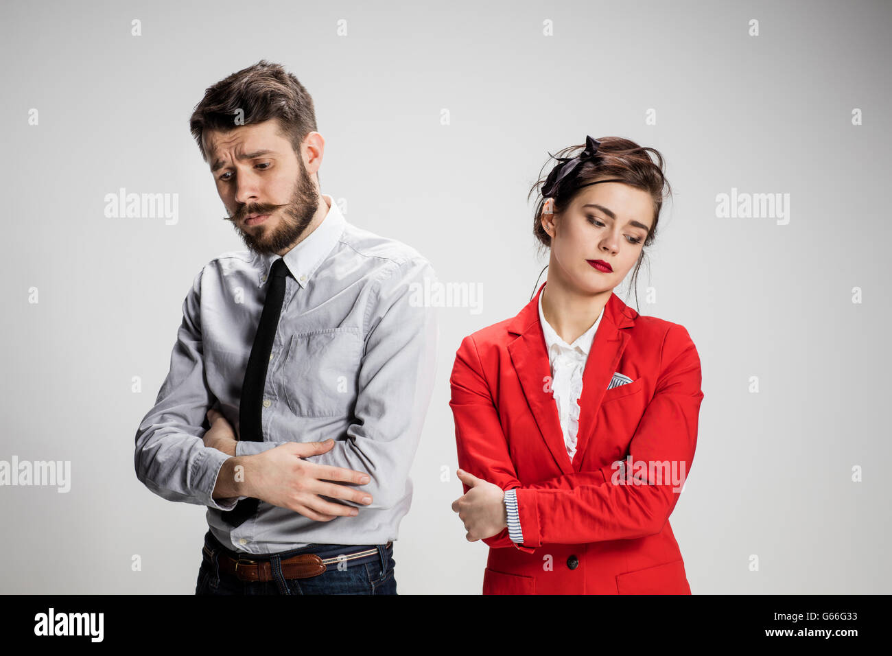 The sad business man and woman conflicting on a gray background Stock ...