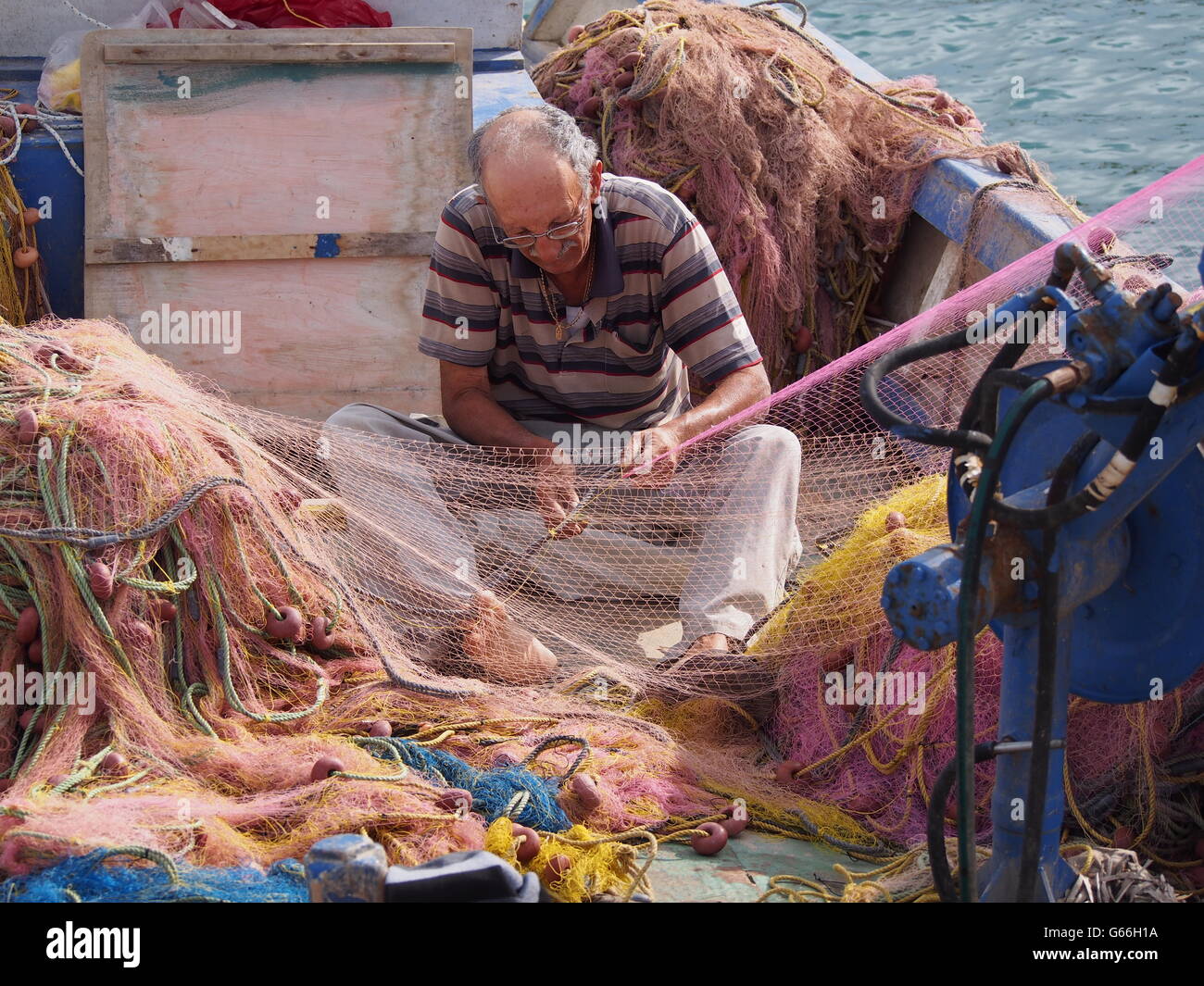 Fisherman attending net Stock Photo