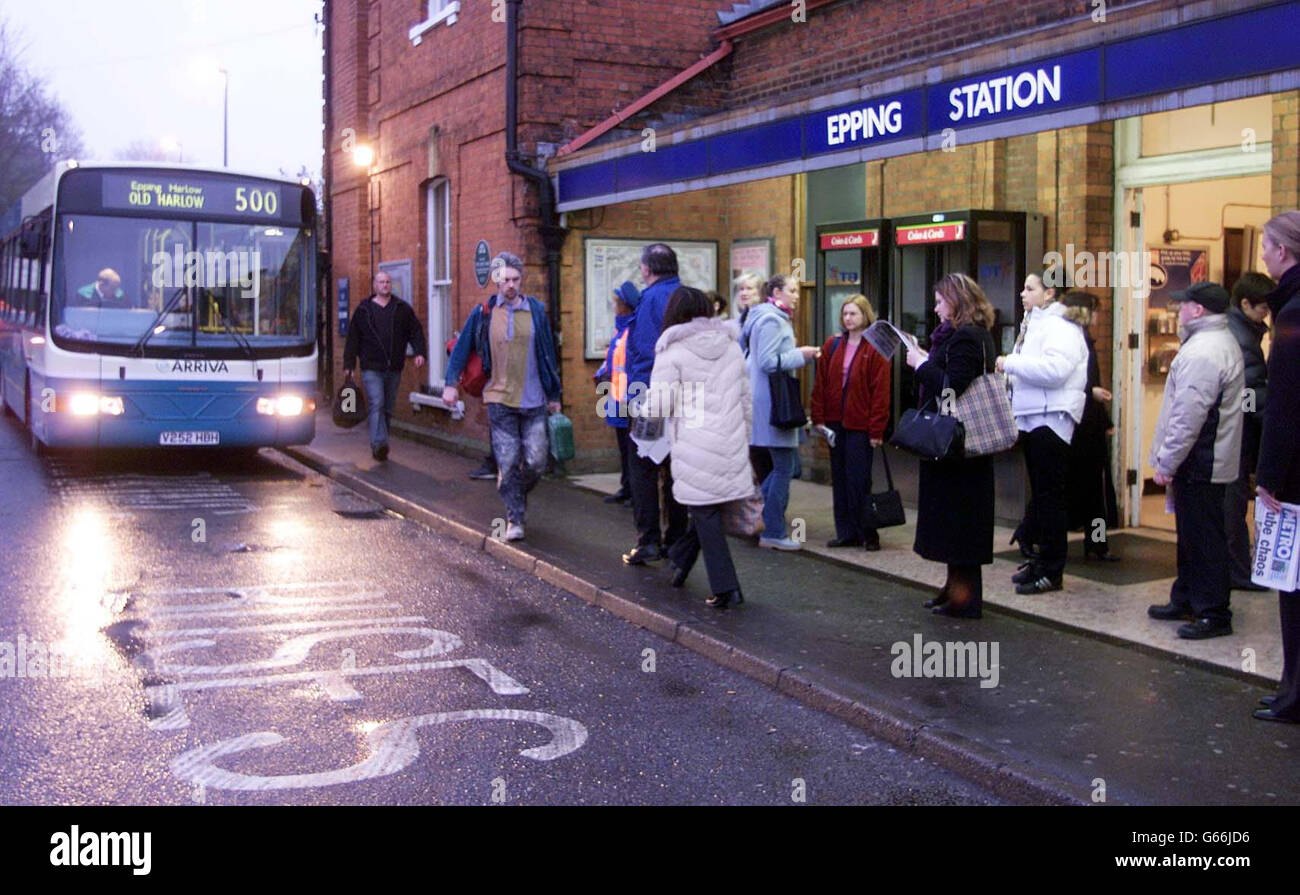 Commuters awaiting a rail replacement bus service at Epping Underground station in Essex after the busy Central Line remained closed after a derailment which left 32 people injured on the London Underground. Stock Photo