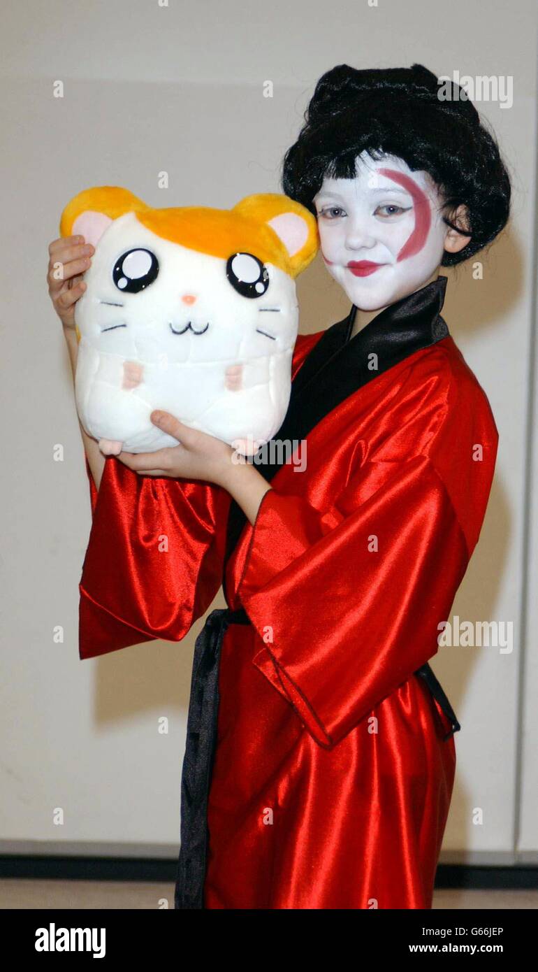 Rhinna Calvert from Guildford holding a new toy called Hamtaro during a photocall at the Toy Fair, at the Excel Centre in London's Dockland. Hamtaro, a hamster who gets himself into lots of mischief, is a $2.5 billion property in Japan. * .... and follows the TV animated story of Laura and the adventures she has with her pet hamster. Stock Photo