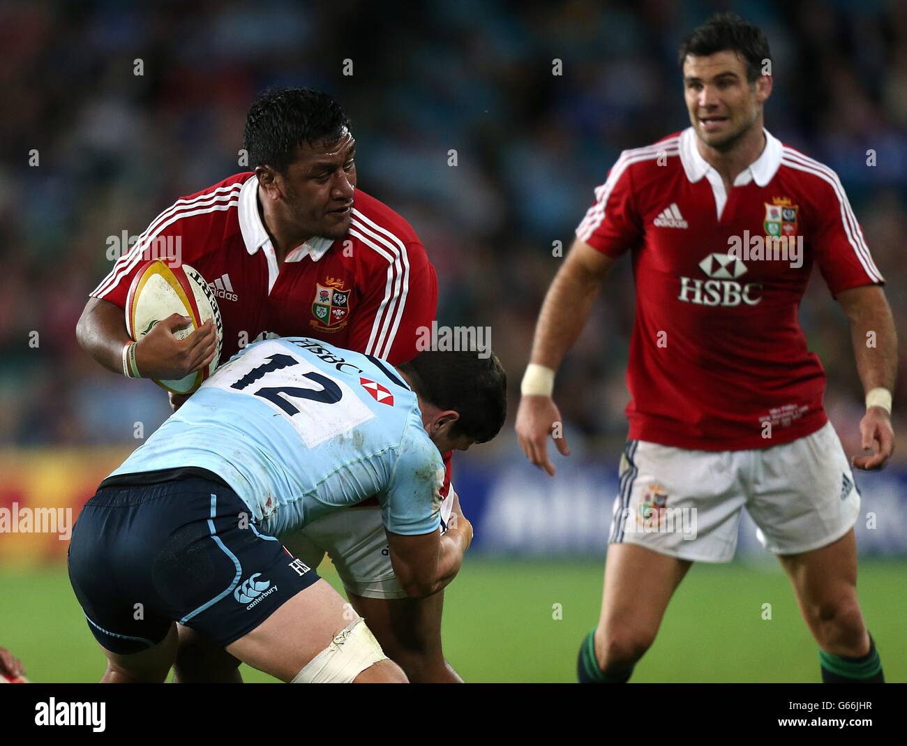 British & Irish Lions' Mako Vunipola gets tackled by NSW Waratahs' Tom Carter Stock Photo