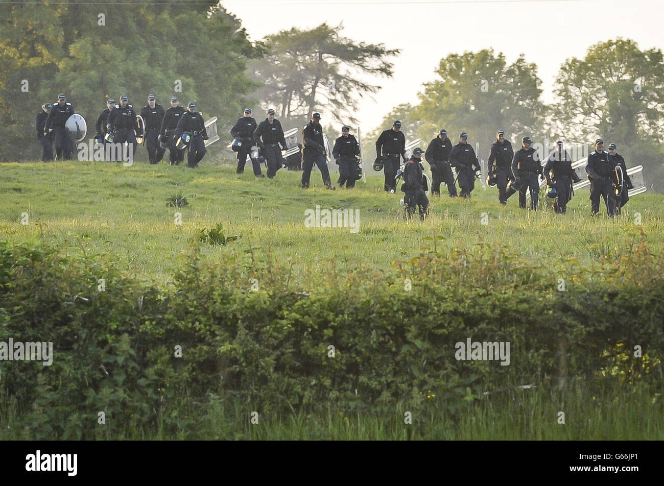 Police advance with riot gear as protesters breach a wire fence at the outer perimeter of the security cordon at the G8 summit in Loch Erne, Enniskillen. Stock Photo