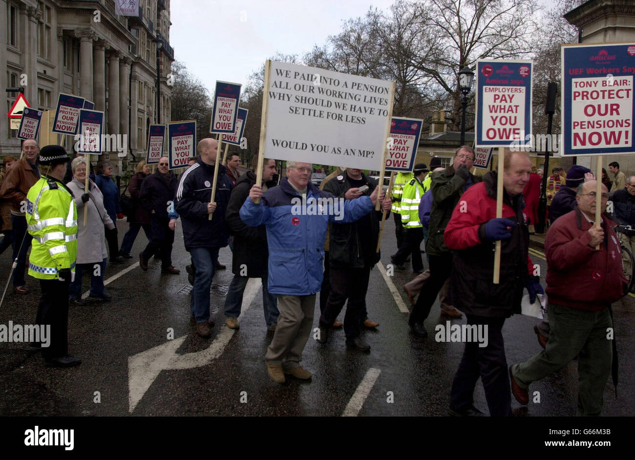 Engineering workers march through Westminster in central London, as around 400 of them protested against pensions which were slashed after the firm United Engineering Forgings (UEF) went into insolvency in 2001. *... The Transport and General Workers Union claimed the company's pension fund was 'raided' to pay for redundancies, threatening pension payments to about 1,300 staff at UEF factories in Ayr, the Midlands and Yorkshire. Stock Photo