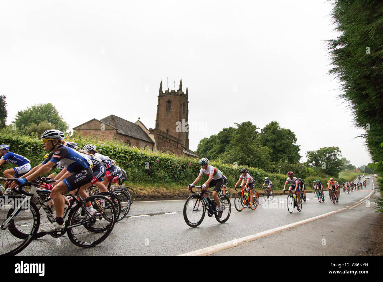 The 2016 Women's Tour pass St Laurence Church along the Nuneaton Road near Ansley in Warwickshire on stage two of the race. Stock Photo
