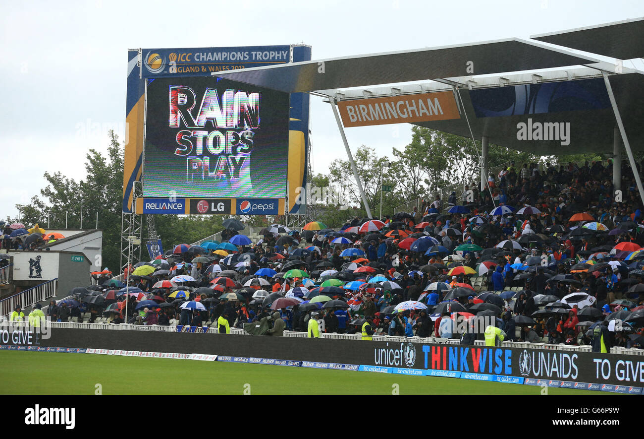 The scoreboard reads 'Rain Stops Play' as the rain falls during the ICC Champions Trophy Final at Edgbaston, Birmingham. Stock Photo