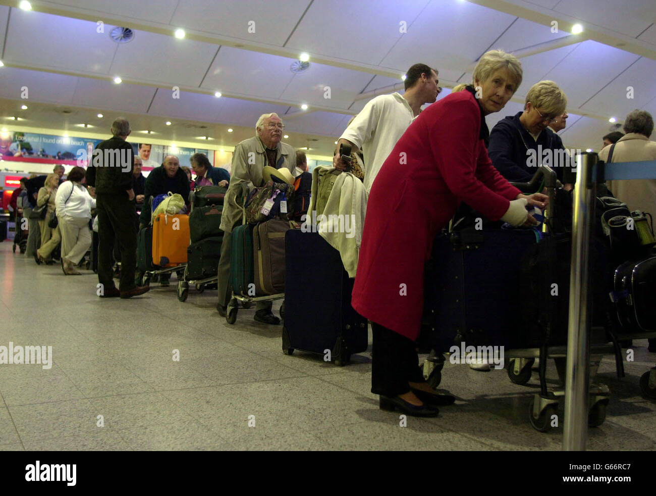Passengers queue inside Gatwick Airport's South Terminal following the