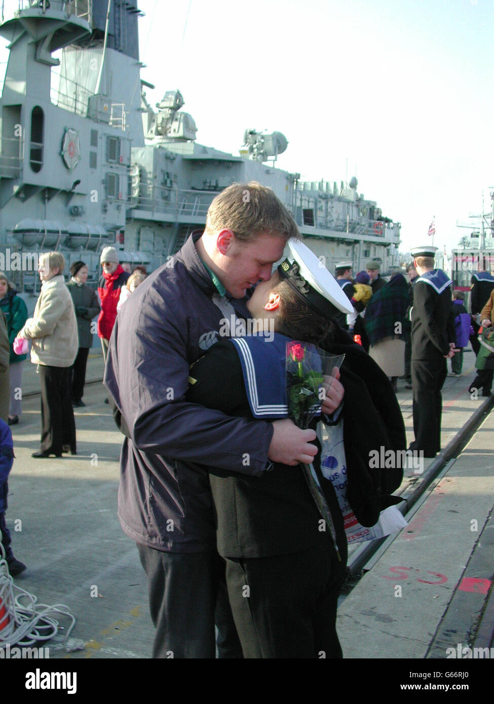 Families and sweethearts enjoyed a Valentine's Day reunion as a warship returned home from an eight-month voyage. HMS Cumberland leading writer Jane Pizii and boyfriend Paul Lister, both from Cornwall, reunited at Plymouth Devonport. * as Jane returns from 8 months at sea. Stock Photo