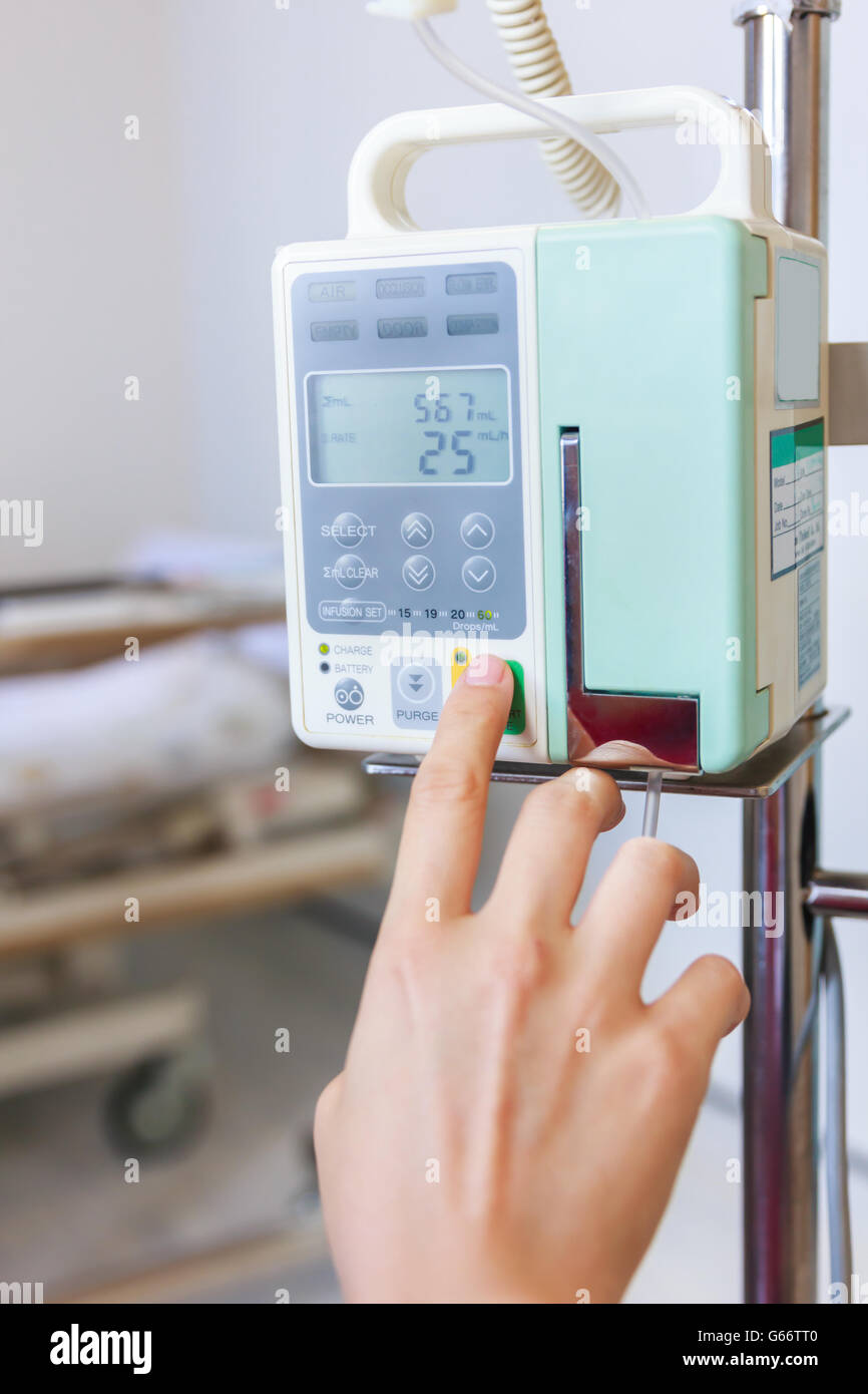 Nurse's hands regulation infusion pump intravenous IV drip in hospital