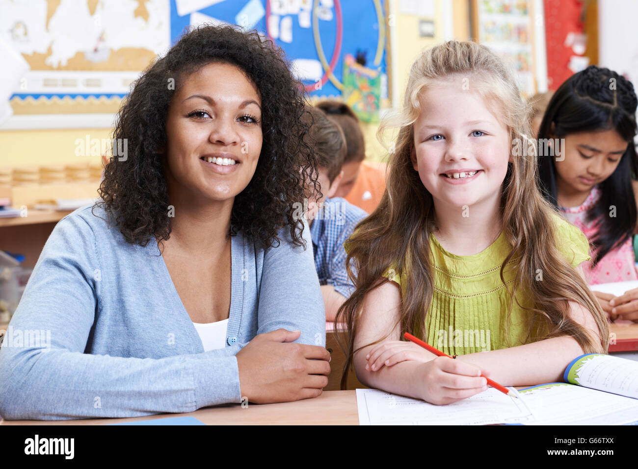 Portrait Of Teacher With Female Elementary School Pupil In Class Stock ...