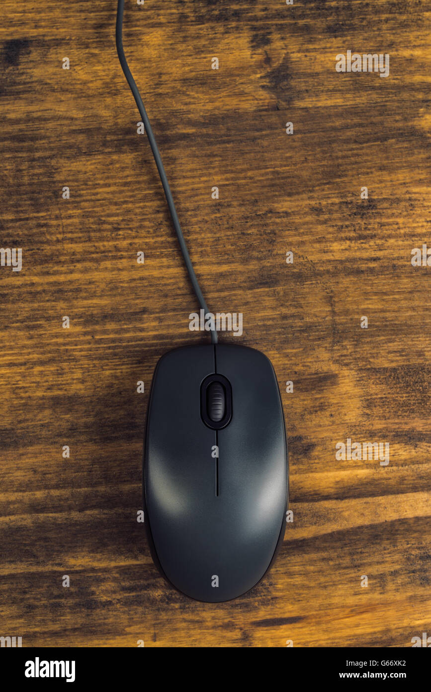 Computer mouse with cord on office desk, top view Stock Photo
