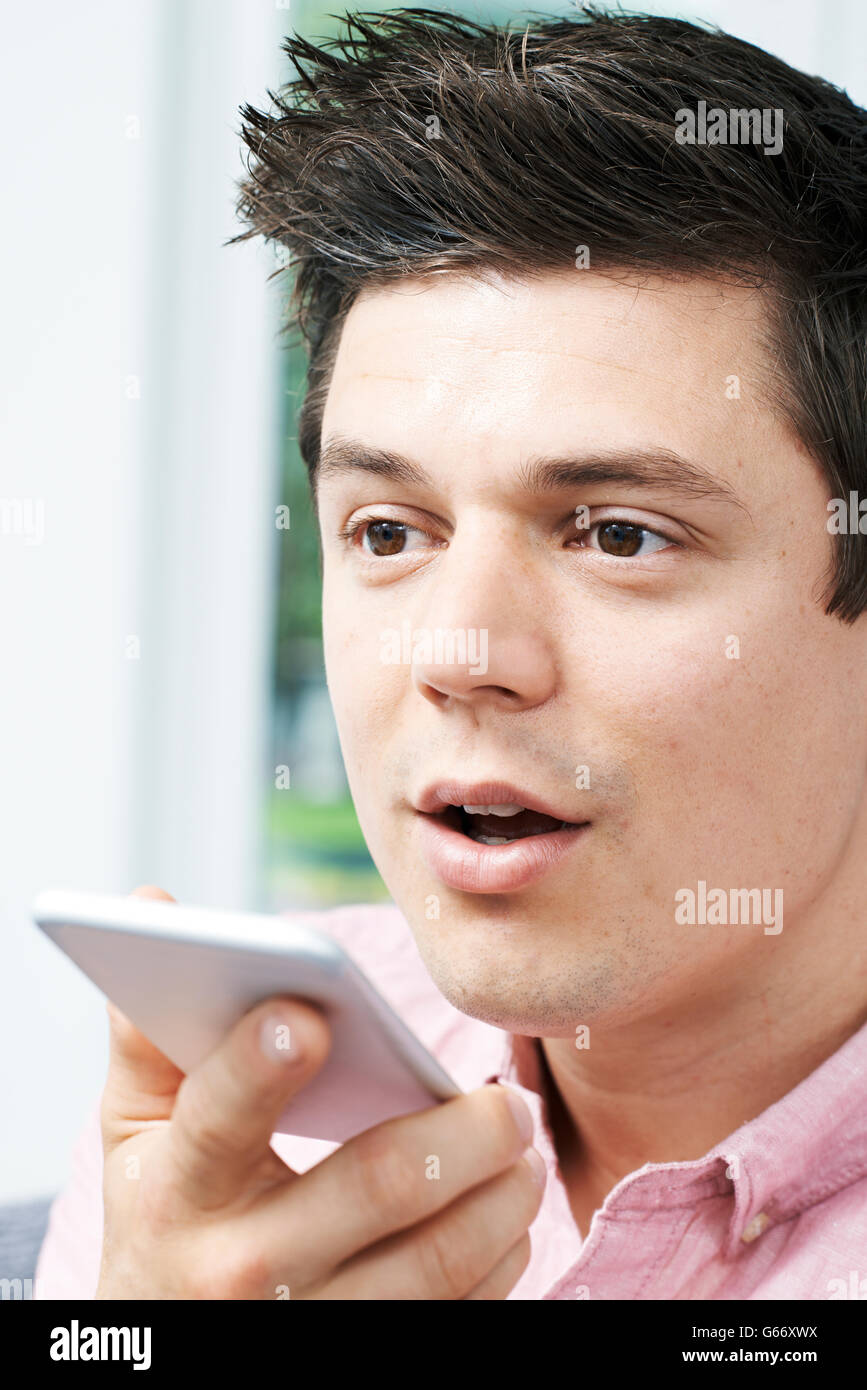 Man Using Internet Voice Search Technology On Mobile Phone Stock Photo