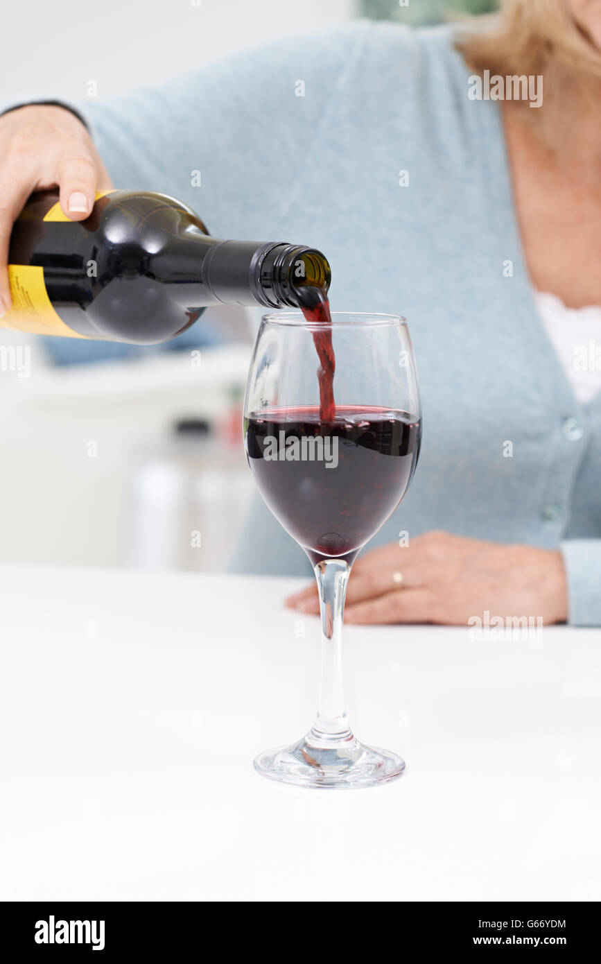 Close Up Of Woman Pouring Large Glass Of Red Wine Stock Photo