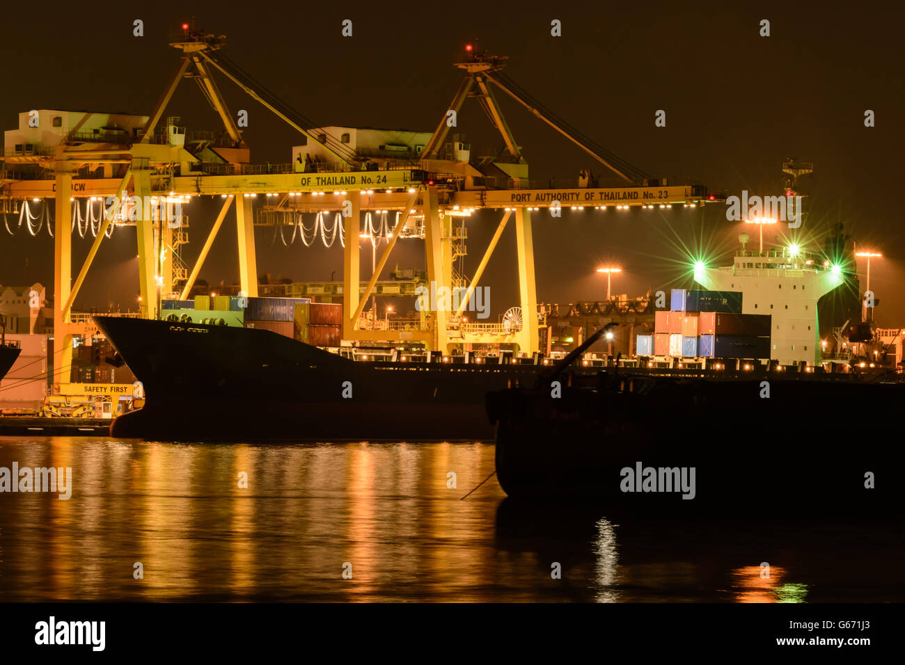Cargo ship moving load at port Stock Photo