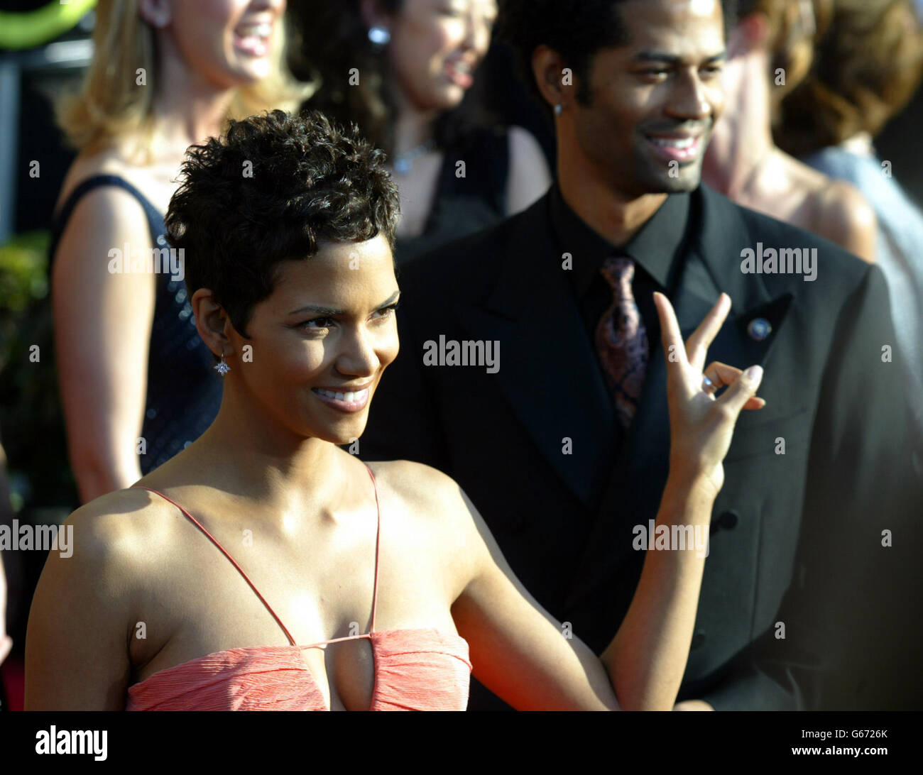 Actress Halle Berry flashes a peace sign as she arrives on the red carpet for the 9th annual Screen Actors Guild Awards at the Shrine Auditorium in Los Angeles. 21/04/2003: Oscar winner Halle Berry is expected to attend a British premiere of the X-Men 2 later this month, it was confirmed, Monday April 21, 2003. The screen siren has been invited to the fundraising event in Edinburgh, which aims to raise cash for diabetes research. Berry, who herself has diabetes, is being invited by fellow sufferer Brian Cox, who stars alongside her in the science fiction movie. Stock Photo