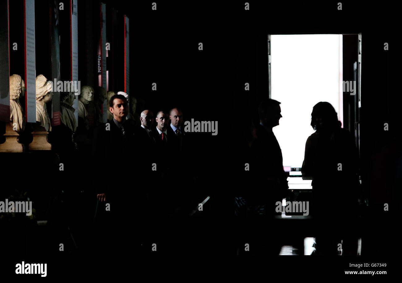 US First Lady Michelle Obama is silhouetted in the doorway with Provost Dr. Patrick Prendergast watched by the Secret Service during their visit to the Long Hall Library in Trinty where they also viewed the World Famous Book of Kells. Stock Photo