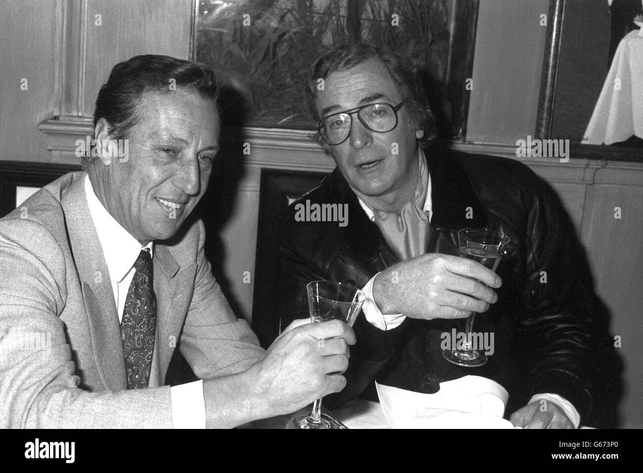 News,- Michael Caine and Frederick Forsyth - Langan's Brasserie - London. 8 million film of Forsyth's novel The Fourth Protocol. Stock Photo