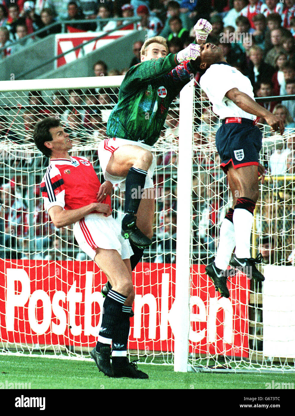 Norway's goalkeeper Erik Thorstvedt (centre) punches clear under pressure from England forward Les Ferdinand from England in Oslo, where England lost 2-0, in the World Cup qualifying match. Stock Photo