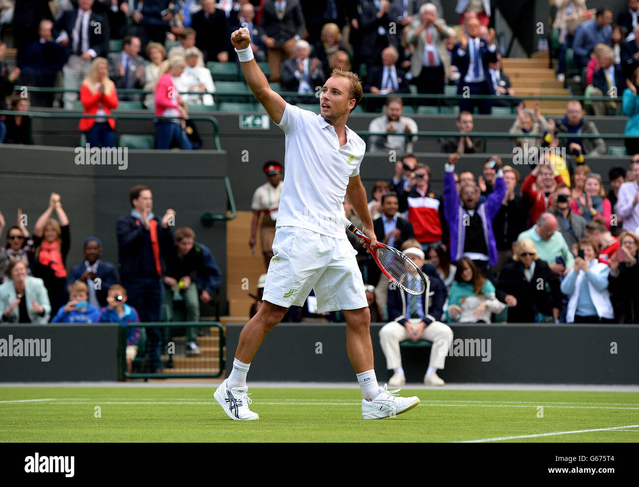 Belgium's Steve Darcis acknowledges the crowd after beating Spain's Rafael Nadal during day one of the Wimbledon Championships at The All England Lawn Tennis and Croquet Club, Wimbledon. Stock Photo