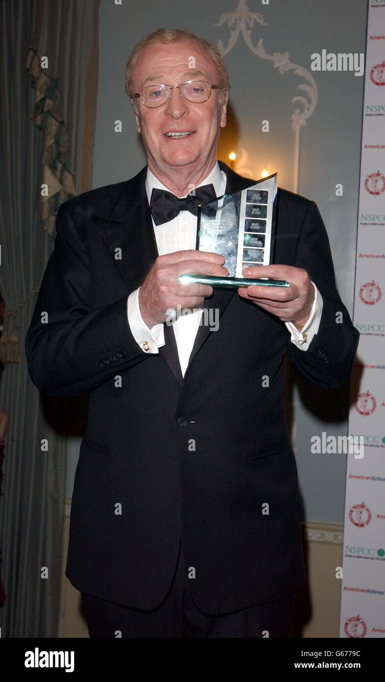 Tuxedo bow tie holding award smiling actor celebrity awards hires