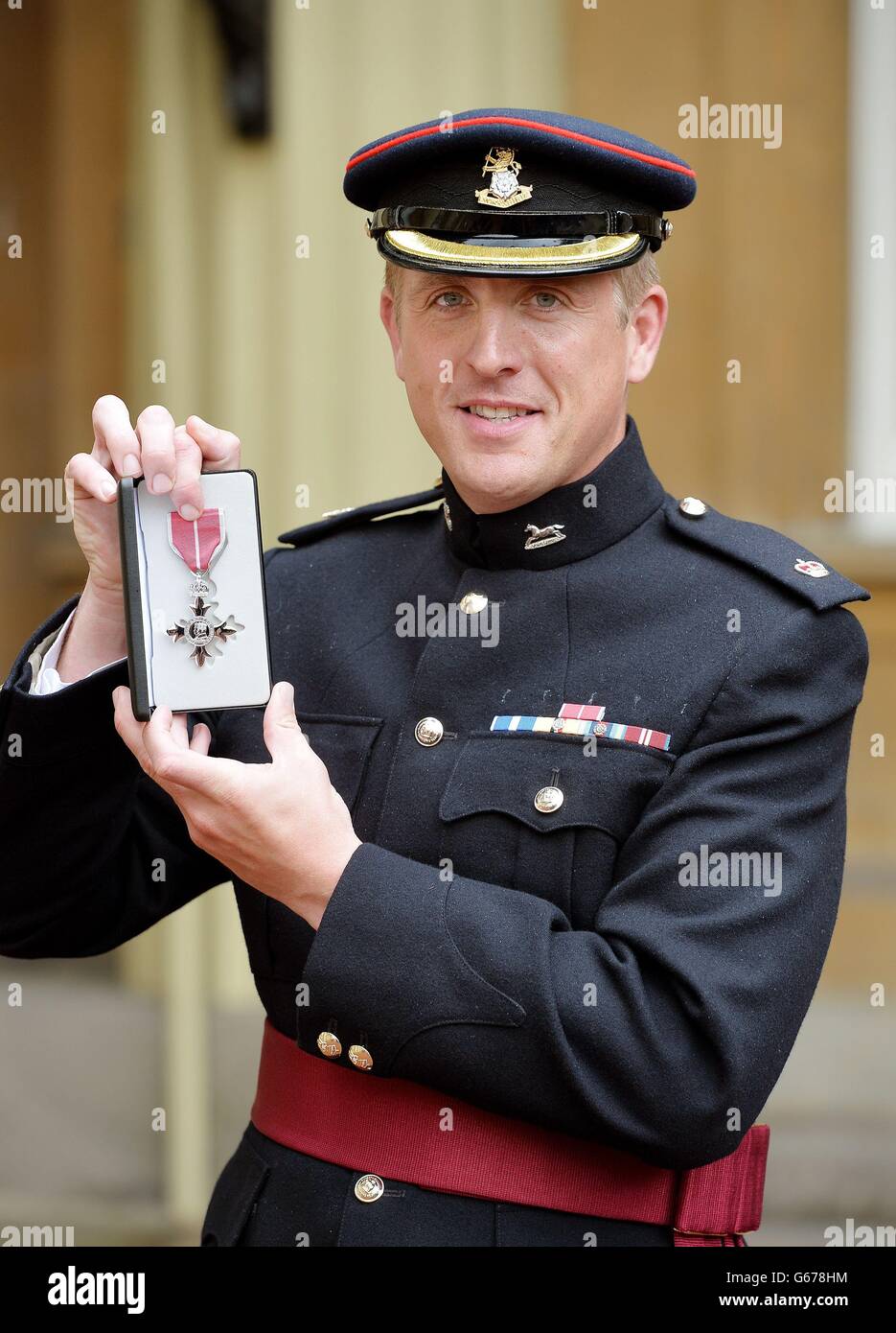 Major Edward Colver from OC Corunna Company, 3rd Bn The Yorkshire Regiment, holds his MBE medal, after he received the award from the Prince of Wales during an Investiture ceremony at Buckingham Palace in central London. Stock Photo