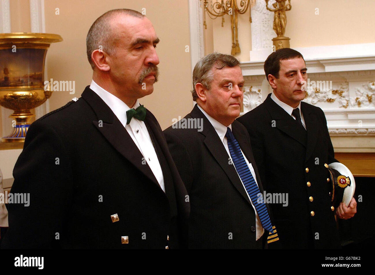 Raymond John Wallace from Devon (L), Malcolm Dailey from stockton (C) and Alexander Donald Macleod from Amble, Northumberland, waiting to be decorated by the Russian Ambassador Grigory Mavrin at the Russian Embassy in London, *..for the salvage operation off the ill-fated Russian submarine Kursk in August 2002. The Russian Kursk sank in the Barents Sea on August 12, 2000, with the loss of all 118 crew after two explosions tore open its hull while it was submerged. Stock Photo