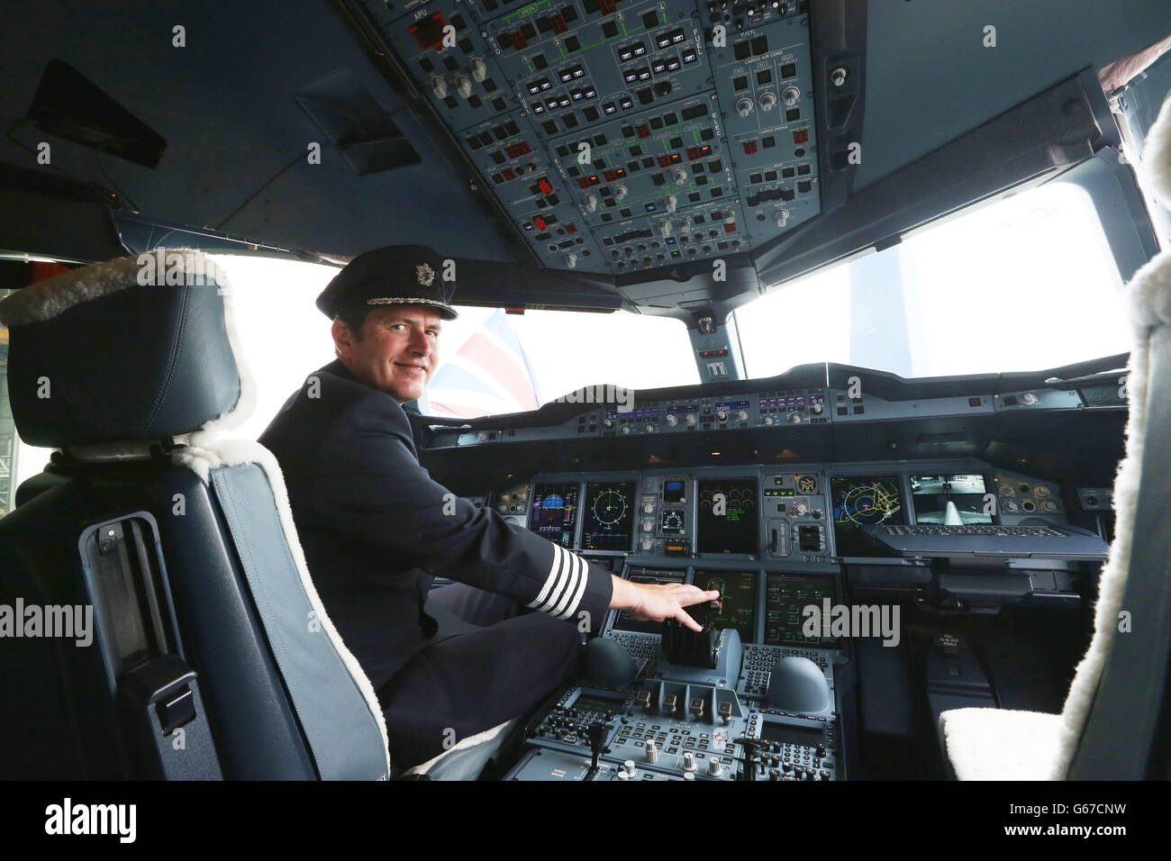 British Airways Captain Mike Blythe on the flight deck of a British Airways Airbus A380, the world's largest passenger plane, after it arrived at Heathrow Airport, as BA became the first UK airline to take delivery of the massive superjumbo. Stock Photo