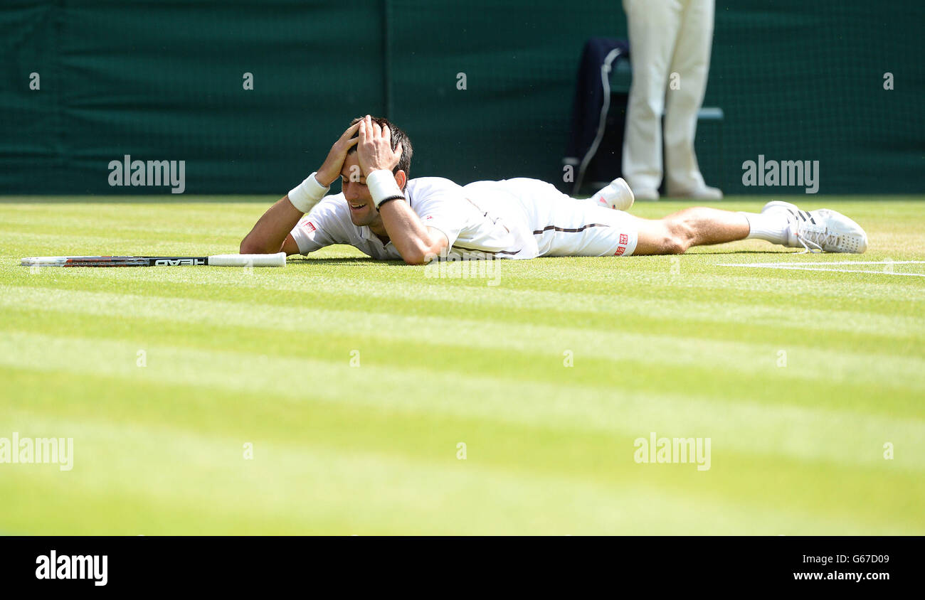 Serbia's Novak Djokovic reacts on the floor after reaching for a shot in his match against Argentina's Juan Martin Del Potro during day eleven of the Wimbledon Championships at The All England Lawn Tennis and Croquet Club, Wimbledon. Stock Photo